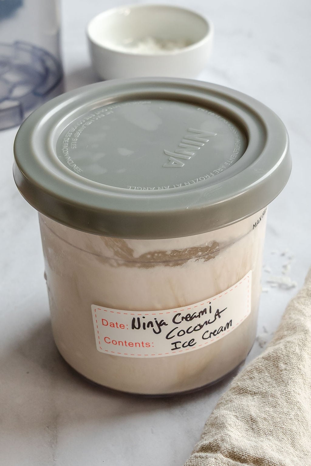 Completed Ninja Creami Coconut Ice Cream in a storage container.