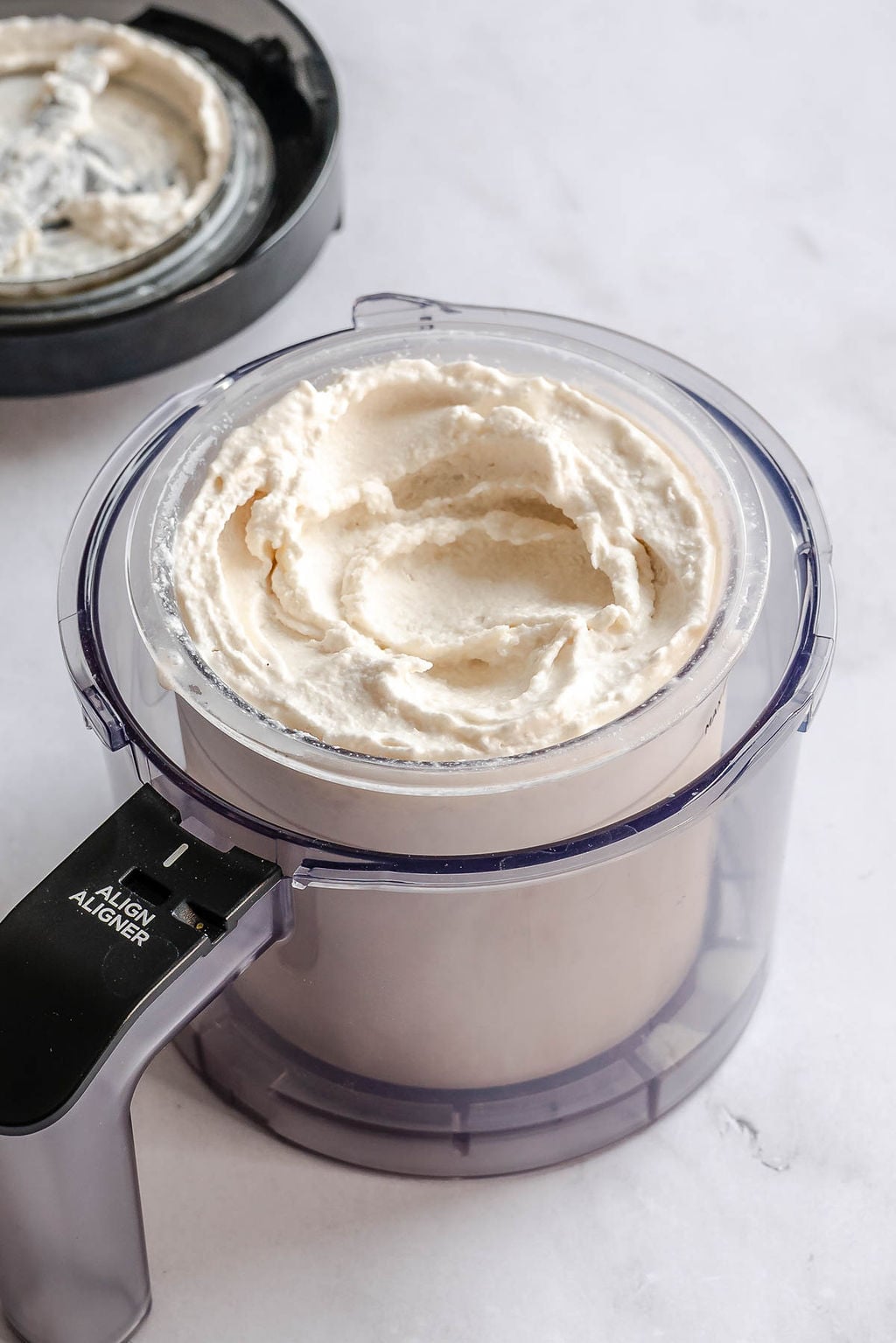 Process shot showing ice cream in container.