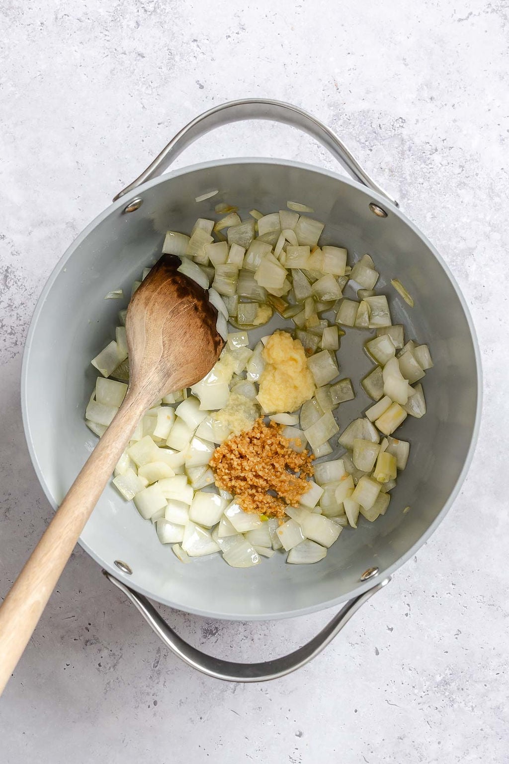 Process shot showing stirring Easy Vegan Laksa ingredients in a pot.