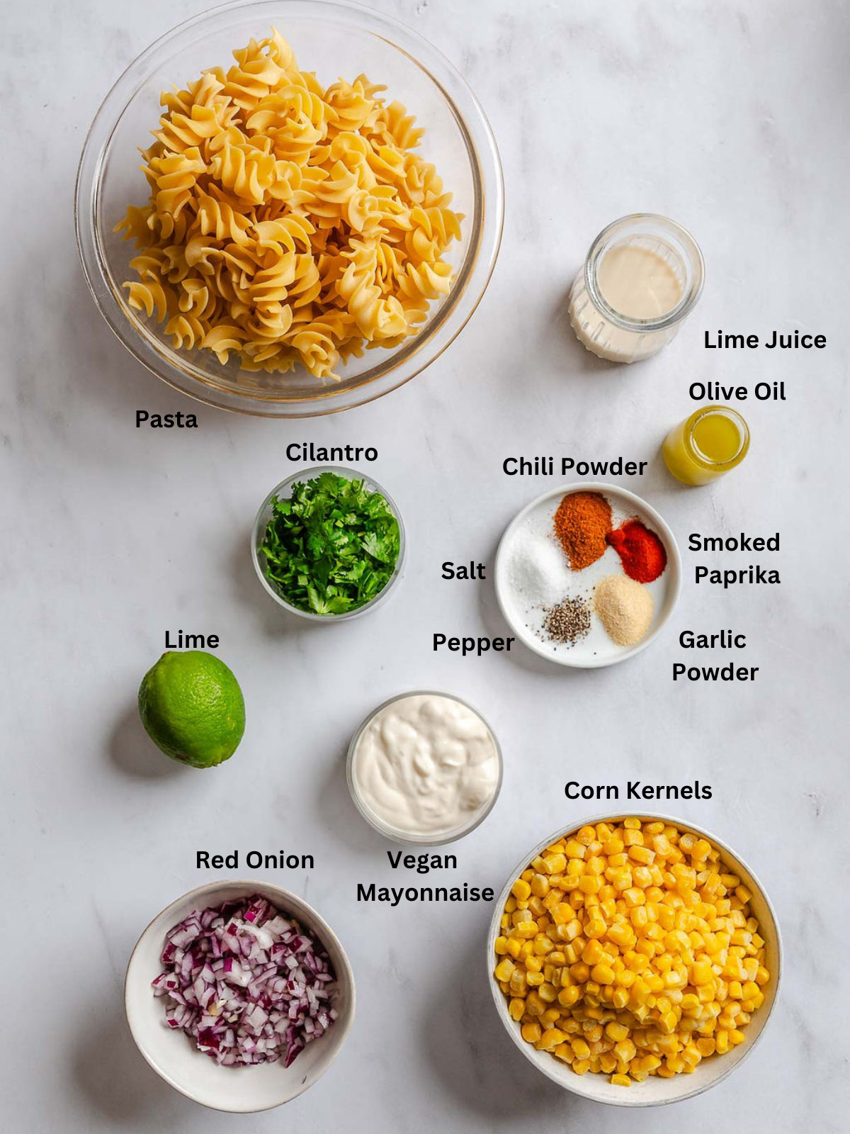 Ingredients for Elote Pasta Salad (Mexican Street Corn) measured out on a white surface.