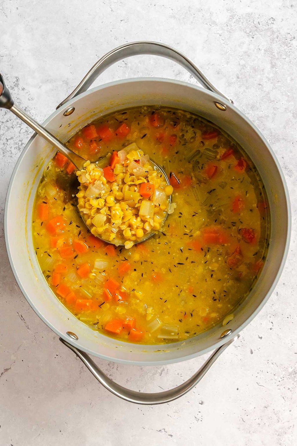 Process shot showing stirring ingredients in a pot.
