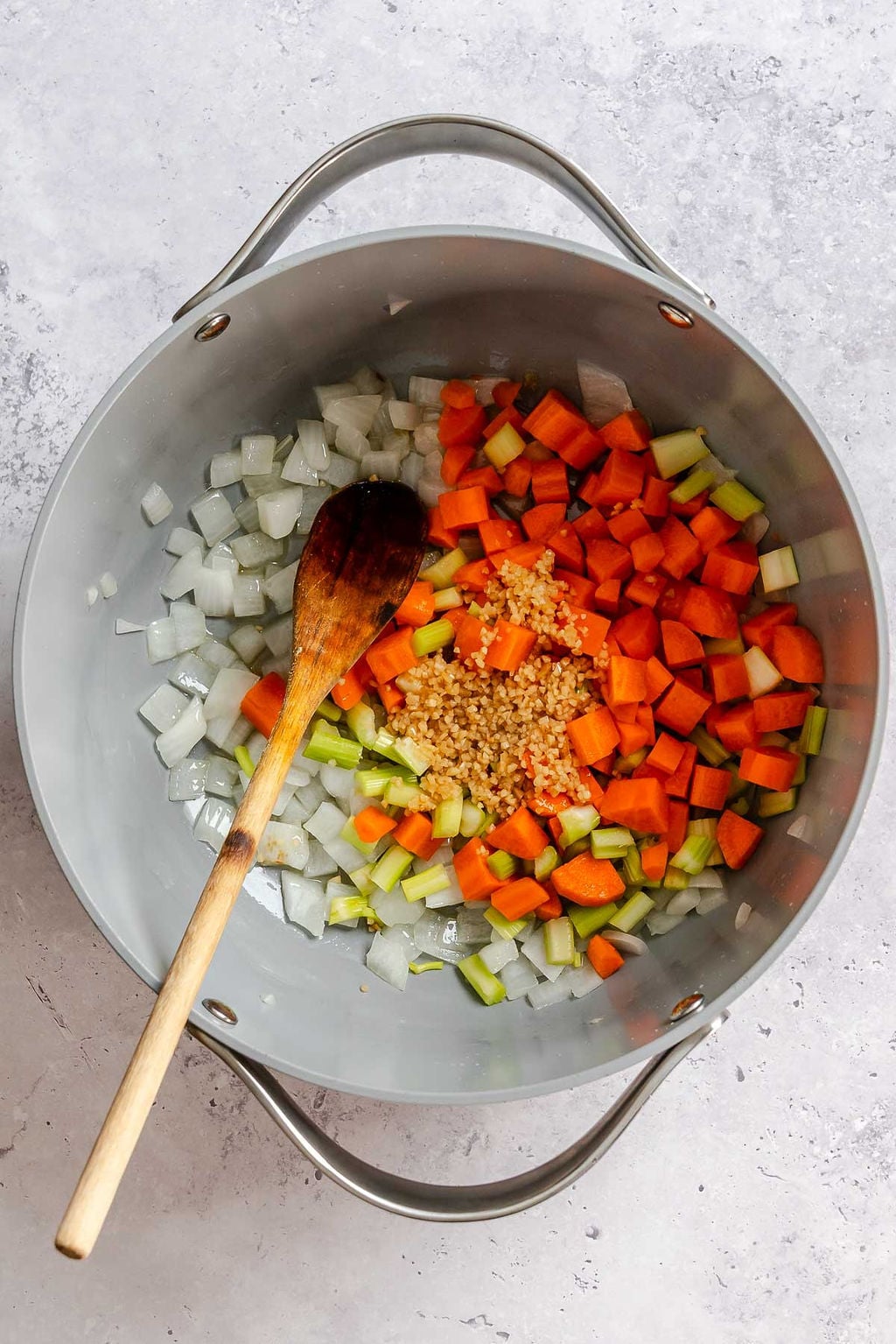 Process shot showing cooking ingredients in a pot.